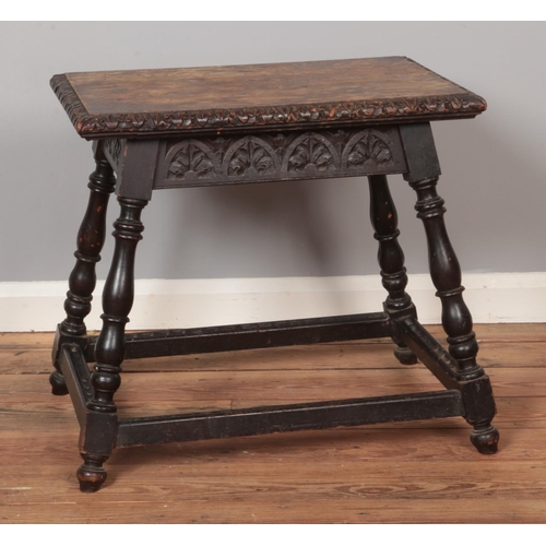 561 - A carved oak occasional table on splayed turned supports.

Hx57cm
Wx66cm
Dx46cm