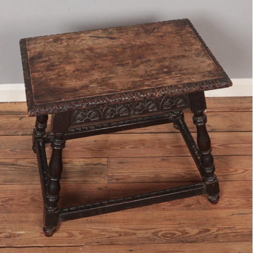 561 - A carved oak occasional table on splayed turned supports.

Hx57cm
Wx66cm
Dx46cm