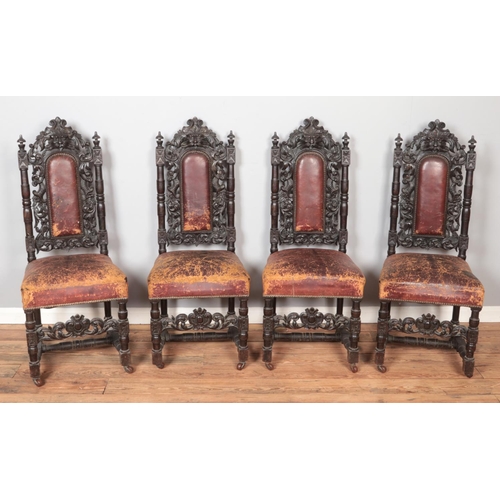 565 - A set of four oak green man chairs with red leather upholstery and on castors