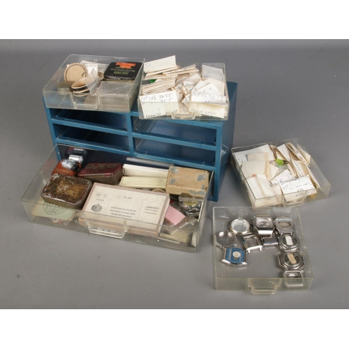 378 - A small set of drawers with watch repair/spares including watch straps, watch cases to include Longi... 