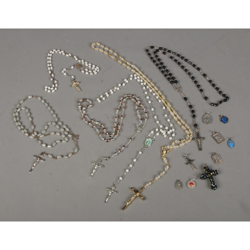 381 - A small quantity of rosary bead necklaces with crosses and other religious themed pendants.