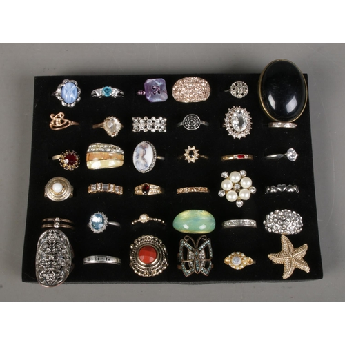 384 - A collection of 36 dress rings.