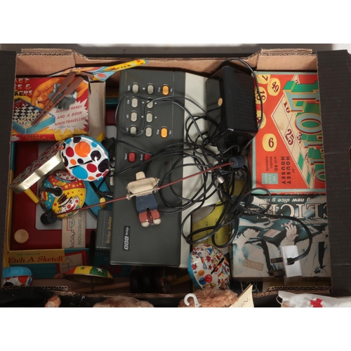 434 - A box of toys and games. Includes Etch A Sketch, parachute action figures, boxed board games, small ... 