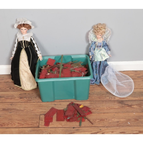 448 - A large box of assorted Meccano pieces along with two porcelain dolls including Alberon Mary Queen o... 