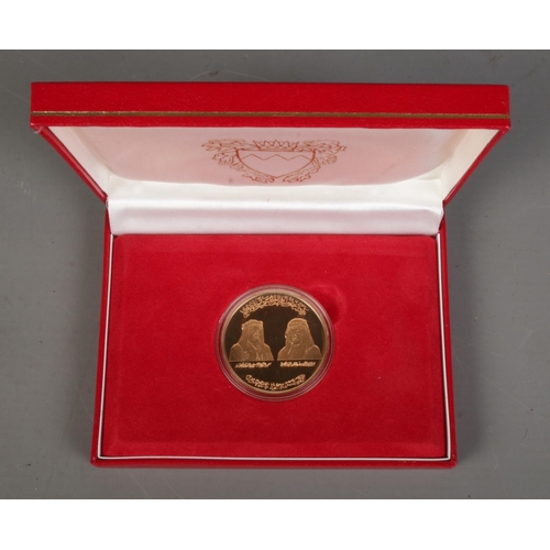 514 - 1986 Bahrain Saudi Causeway gold coin in original display case and sleeve. 31.18g.