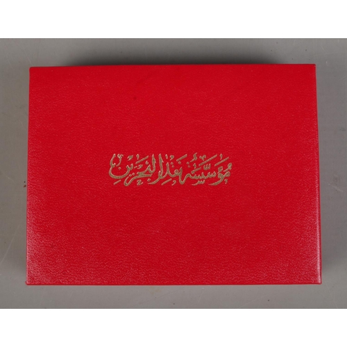 514 - 1986 Bahrain Saudi Causeway gold coin in original display case and sleeve. 31.18g.