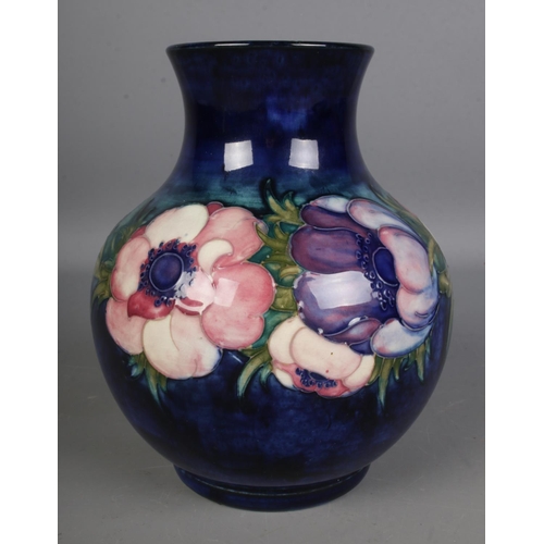 542 - A Moorcroft Pottery vase decorated in the anemone pattern, signed to the base. Hx19.5cm