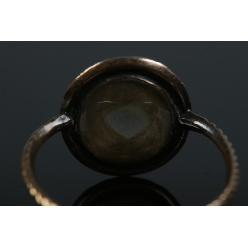 248 - A Georgian yellow metal mourning ring with garnet surround. Size N 1/2. 2.05g.