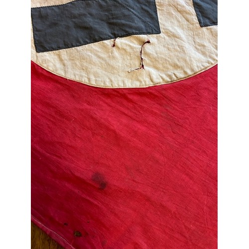 189 - A World War Two period German Nazi Party flag. Red ground with swastika to both sides. 185cm x 72cm.