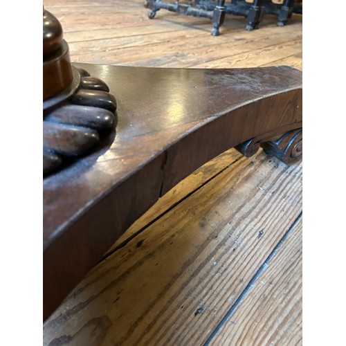 312 - A Victorian rosewood supper table with circular top and carved triform base. Diameter 107cm.