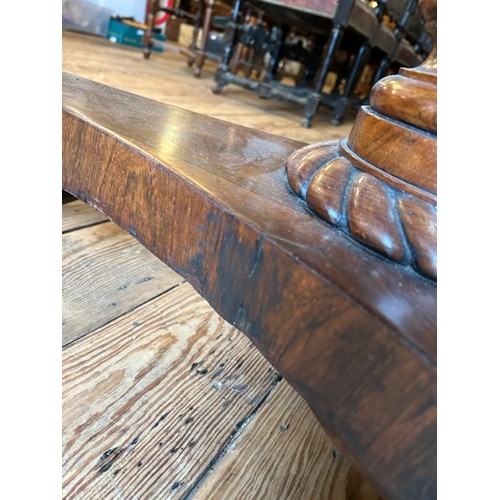 312 - A Victorian rosewood supper table with circular top and carved triform base. Diameter 107cm.