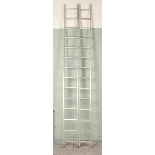 390 - A large pair of extendable metal frame ladders. Two pieces of 353cm.