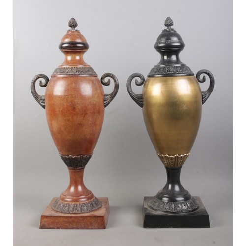 90 - A near pair of bronzed twin handled globular shaped urns, with grape finial and banded floral border... 