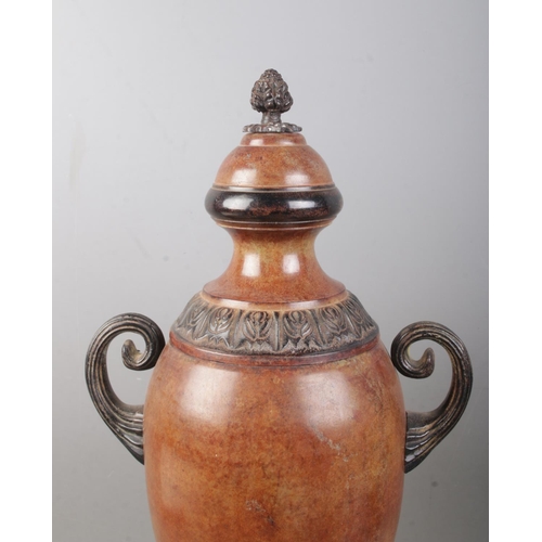 90 - A near pair of bronzed twin handled globular shaped urns, with grape finial and banded floral border... 