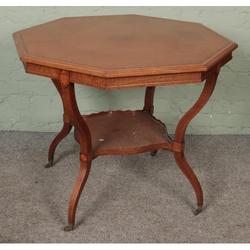 596 - A large Edwardian mahogany inlaid table with shaped legs united by a lower tier shelf on brass casto... 