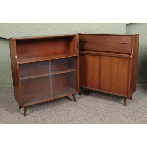 571 - A pair of retro walnut side cabinets. One having glass sliding doors, the other with wooden sliding ... 