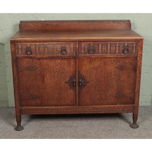 572 - A carved oak sideboard.