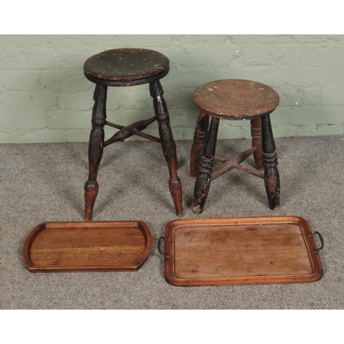 604 - Two antique turned wooden stools including milking example along with two trays.