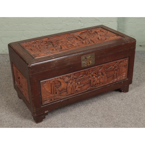 605 - An oriental hardwood carved chest featuring camphorwood lining. Approx. dimensions 101cm x 53cm x 55... 