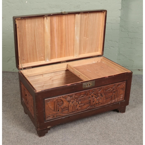 605 - An oriental hardwood carved chest featuring camphorwood lining. Approx. dimensions 101cm x 53cm x 55... 