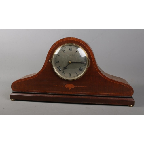 111 - An early 20th century inlaid mahogany dome top mantel clock. Chiming on a coiled gong. The movement ... 