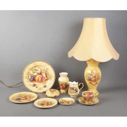 117 - A collection of Aynsley Orchard Gold ceramics to include table lamp, milk jug, plates, small vase, e... 