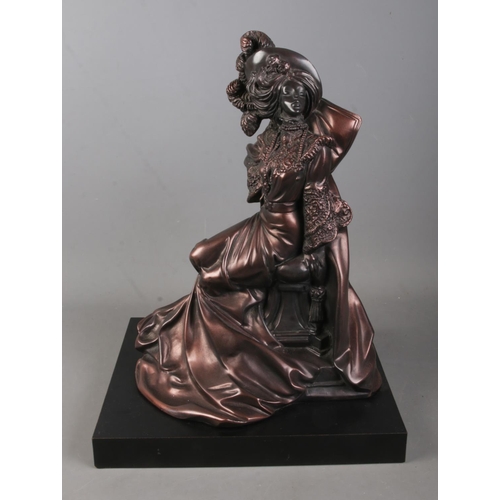 127 - A bronzed figure of a seated woman by Austin Sculptures titled Daisy to reverse. Approx. height 45cm... 