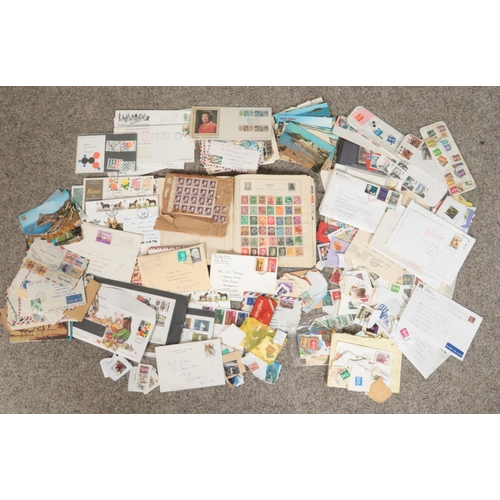 150 - A box of British and world stamps. Includes examples in a The Strand album, loose, on envelopes, pos... 