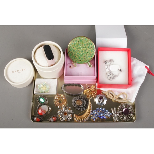 155 - A collection of costume jewellery. Includes Mirage, Mizpah and other brooches, Radley watch, Guess p... 