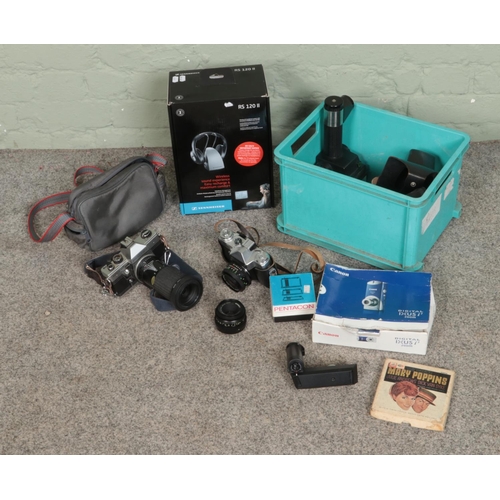 211 - A box of assorted cameras and accessories to include Zenit-E, Praktica MTL 5B, Sennheiser headphones... 