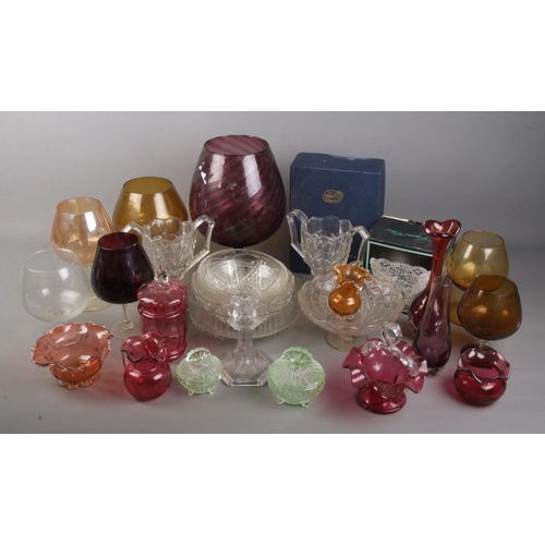 283 - A box of glassware. Includes Victorian cranberry glass, large coloured glass goblets, boxed Bohemia ... 