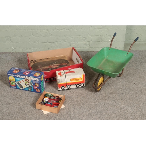 311 - A box of vintage children's toys and games to include Revell Nova Home Racing Kit, Videomaster Colou... 