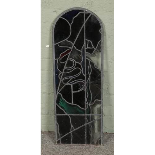 362 - An arched leaded stained glass window. Approx. dimensions 34cm x 96cm.