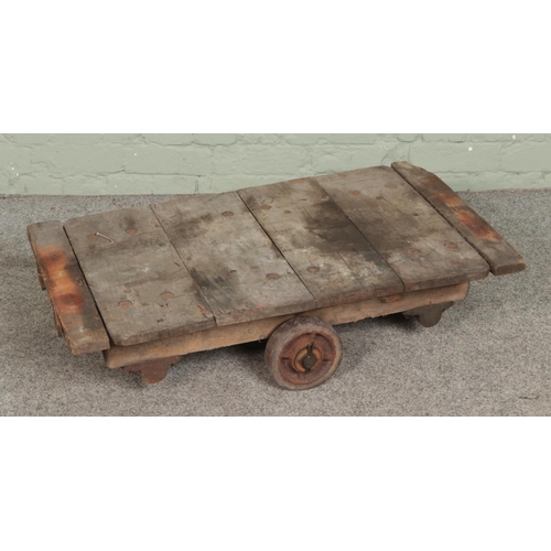 375 - An industrial four wheel trolley. Approx. dimensions 91cm x 51cm.