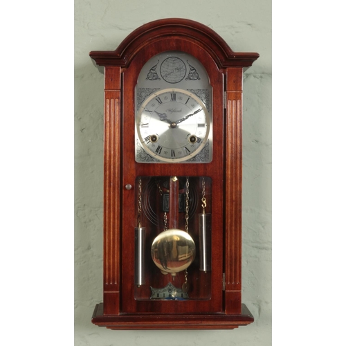 418 - A Highlands mahogany twin weight wall clock. Chiming on a coiled gong.