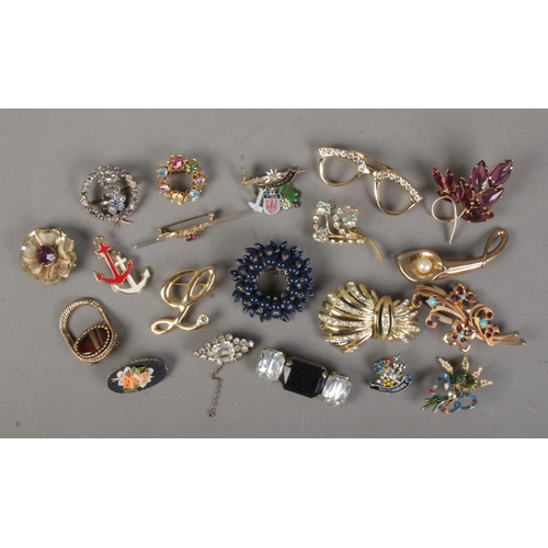 72 - Twenty costume jewellery brooches. Includes enamelled and paste set examples.