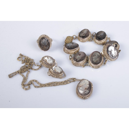 435 - A white metal shell cameo jewellery suite featuring bracelet, ring, earrings and necklace. Makers ma... 