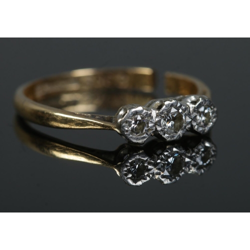 447 - An 18ct Gold and Platinum three stone diamond ring. Size O. Total weight: 2.2g.