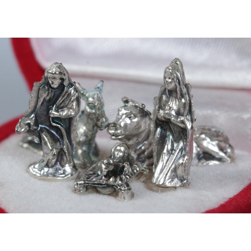 480 - A cased miniature five piece white metal nativity scene.