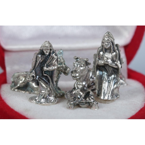 480 - A cased miniature five piece white metal nativity scene.