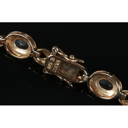 487 - A silver gilt bracelet set with sapphire and diamond stones, along with a silver pendant on chain.