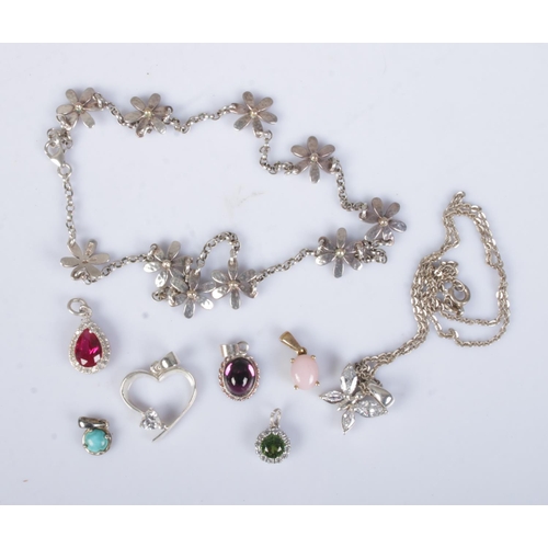 488 - A collection of silver pendants and necklaces to include floral and heart examples. Approx. total we... 