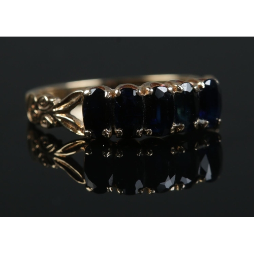 499 - A 9ct gold five stone sapphire ring. Size O. 2.2g.