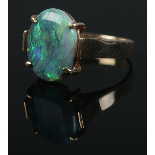 500 - A 9ct gold opal doublet ring. Size of stone approximately 1.5cm x 1cm. Size K 1/2. 3.6g.