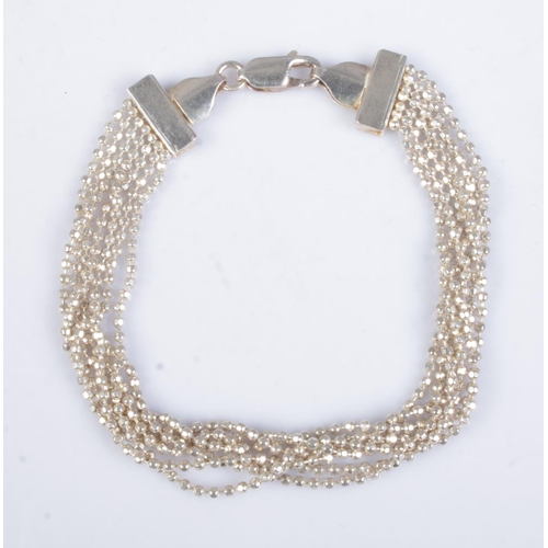 504 - A small silver bracelet formed as seven chains. Approx. total weight 7.6g.