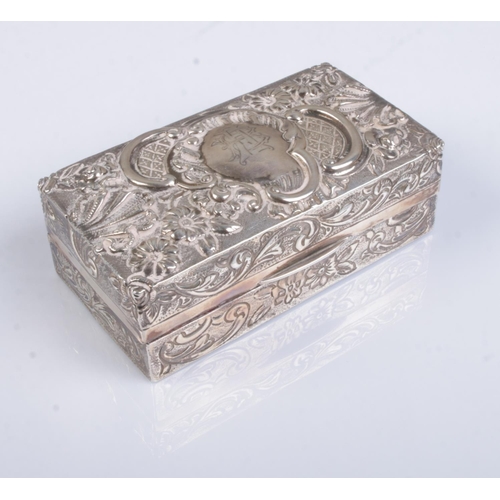 516 - A Victorian silver box with repousse decoration and monogrammed top. Assayed London 1894 by Samuel S... 