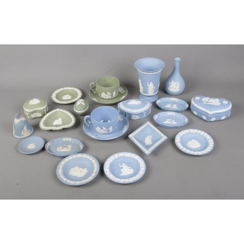 100 - A collection of Wedgwood jasperware in light blue and green to include vase, trinket boxes, cup and ... 