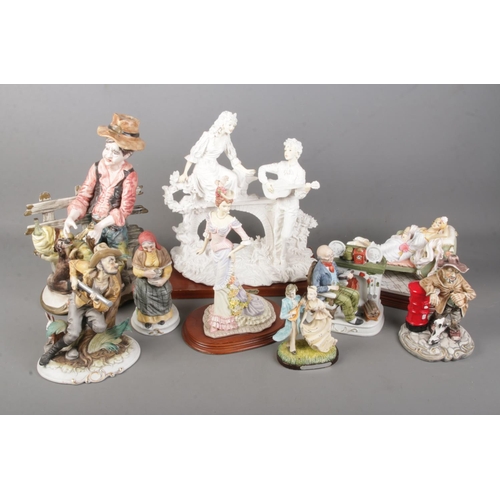 110 - A collection of ceramic figures including Capodimonte and  The Leonardo collection examples.