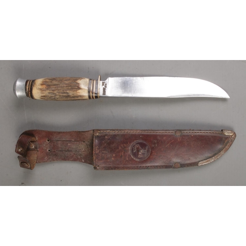 195 - A Solingen Rostfrei hunting knife with antler horn handle and leather scabbard. CANNOT POST OVERSEAS