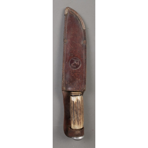 195 - A Solingen Rostfrei hunting knife with antler horn handle and leather scabbard. CANNOT POST OVERSEAS